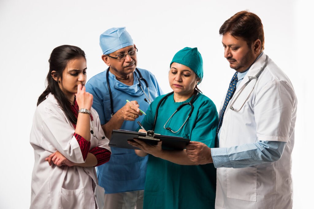 Team of doctors and nurses reviewing patient records together